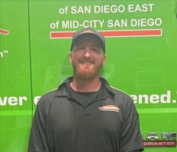 SERVPRO employee in black polo posing for crew photo.