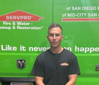 Man in front of green truck