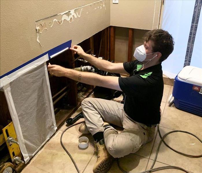technician setting up containment from water damage