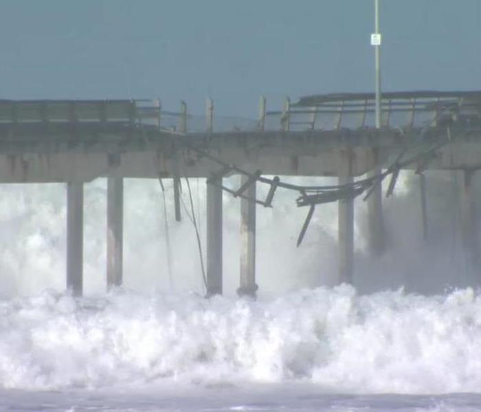 The Ocean Beach Pier being washed away