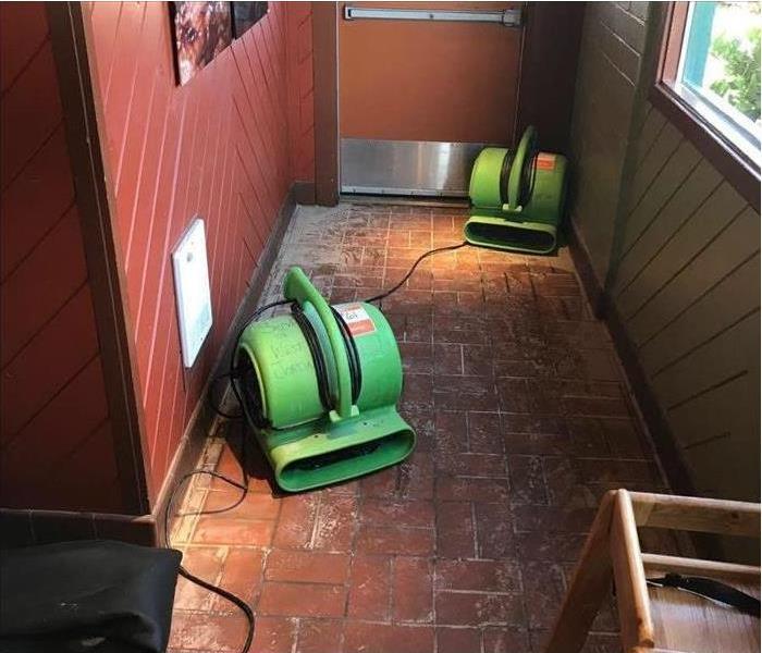 Two air movers in the hallway of a restaurant